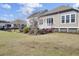 Lush backyard featuring rose bushes with access to the deck and patio at 345 Turnstone St, Mount Pleasant, SC 29464