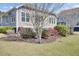 A spacious backyard with neatly trimmed landscaping, mulch, and thriving rose bushes at 345 Turnstone St, Mount Pleasant, SC 29464