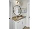 Elegant bathroom vanity with granite countertop, framed mirror, and white cabinets at 345 Turnstone St, Mount Pleasant, SC 29464