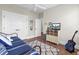 Cozy bedroom with neutral walls, white trim, hardwood floors, and a TV atop a cabinet with woven storage baskets at 345 Turnstone St, Mount Pleasant, SC 29464