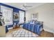 Bright bedroom featuring a blue accent wall, hardwood floors, and plenty of natural light from two windows at 345 Turnstone St, Mount Pleasant, SC 29464