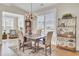 Elegant dining room with hardwood flooring, chandelier, and natural light from shuttered windows at 345 Turnstone St, Mount Pleasant, SC 29464