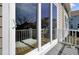 The glass doors lead to a back deck with a view into the home's open kitchen and seating at 345 Turnstone St, Mount Pleasant, SC 29464