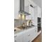 Kitchen featuring stainless steel appliances, white cabinets, gas range, and tile backsplash at 345 Turnstone St, Mount Pleasant, SC 29464