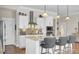 Kitchen with white cabinets, tile backsplash, marble countertops, stainless steel appliances, and bar seating at 345 Turnstone St, Mount Pleasant, SC 29464