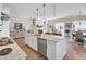 Open-concept kitchen with marble counters, island sink, stainless steel appliances, and hardwood floors at 345 Turnstone St, Mount Pleasant, SC 29464