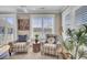 Cozy living area with two armchairs, plantation shutters, and view of a manicured landscape at 345 Turnstone St, Mount Pleasant, SC 29464