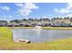 Picturesque pond view with a fountain, surrounded by lush greenery and well-maintained community landscaping at 345 Turnstone St, Mount Pleasant, SC 29464