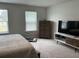 A bedroom with two windows offers a serene atmosphere with a dresser and entertainment center at 413 Cedarview Rd, Summerville, SC 29486