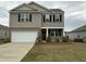 Charming two-story home with a two-car garage, neutral siding, and a well-manicured front lawn on an overcast day at 413 Cedarview Rd, Summerville, SC 29486