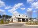 An exterior shot of a clubhouse on a sunny day, complete with covered seating and charming architectural details at 413 Cedarview Rd, Summerville, SC 29486