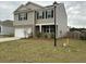 Charming two-story home with a two-car garage, neutral siding, and a well-manicured front lawn on an overcast day at 413 Cedarview Rd, Summerville, SC 29486