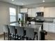 Modern kitchen featuring granite counters, white cabinets, stainless steel appliances, and an eat-in kitchen island at 413 Cedarview Rd, Summerville, SC 29486