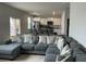 Open-concept living room flowing into the kitchen with a large grey couch and many pillows at 413 Cedarview Rd, Summerville, SC 29486