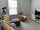 A living room with sectional couch, yellow accents, and a television at 413 Cedarview Rd, Summerville, SC 29486