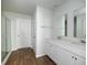 Bright bathroom featuring a double vanity, white cabinets, and wood-look flooring at 436 Cedarview Rd, Summerville, SC 29486