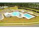 Aerial view of a stunning community pool area with a splash pad, playground, and ample seating for relaxation at 436 Cedarview Rd, Summerville, SC 29486