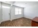 Inviting entryway with wood-look floors, a bright window, and a paneled door, creating a warm welcome at 436 Cedarview Rd, Summerville, SC 29486