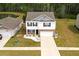 Charming two-story home with a manicured lawn and attached two-car garage and complemented by lush trees in the background at 436 Cedarview Rd, Summerville, SC 29486