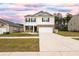 Two-story home featuring white siding and a brick facade, complemented by a well-manicured lawn and ample driveway space at 436 Cedarview Rd, Summerville, SC 29486