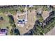 Aerial view of a secluded home with a gravel driveway surrounded by mature trees and lush landscaping at 4846 Causey Pond Rd, Awendaw, SC 29429