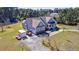 Aerial view of home with well-manicured yard, mature trees, and a circular driveway in a country setting at 4846 Causey Pond Rd, Awendaw, SC 29429