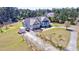 Aerial view of home with well-manicured yard, mature trees, and a circular driveway in a country setting at 4846 Causey Pond Rd, Awendaw, SC 29429