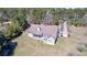 Aerial view of home with well-manicured yard, mature trees, and screened porch in a country setting at 4846 Causey Pond Rd, Awendaw, SC 29429