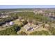 Aerial view showcasing multiple homes surrounded by lush trees, ponds and scenic landscapes at 4846 Causey Pond Rd, Awendaw, SC 29429