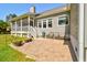 Inviting backyard patio with seating area, steps to the screened porch, and lush lawn at 4846 Causey Pond Rd, Awendaw, SC 29429