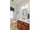 Bathroom featuring marble countertop, wood cabinets, and plenty of light at 4846 Causey Pond Rd, Awendaw, SC 29429