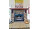 Stone fireplace with a wooden mantel and hearth, perfect for cozy evenings at 4846 Causey Pond Rd, Awendaw, SC 29429