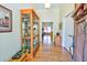 Inviting foyer with hardwood floors, display case, and view to the living area at 4846 Causey Pond Rd, Awendaw, SC 29429