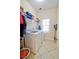 Laundry room equipped with washer, dryer, and storage shelves at 4846 Causey Pond Rd, Awendaw, SC 29429