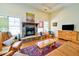 Cozy living room with hardwood floors, a stone fireplace, and comfortable seating at 4846 Causey Pond Rd, Awendaw, SC 29429