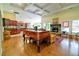 Open-concept living room with hardwood floors, a fireplace, and a view of the kitchen at 4846 Causey Pond Rd, Awendaw, SC 29429