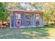 Utility shed with rustic wood and twin windows; ideal for gardening or workshop space at 4846 Causey Pond Rd, Awendaw, SC 29429