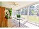 Bright and airy screened porch with a ceiling fan and table, perfect for enjoying the outdoors at 4846 Causey Pond Rd, Awendaw, SC 29429