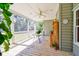 Relaxing screened porch featuring a ceiling fan, table with lush plants, and stylish decor at 4846 Causey Pond Rd, Awendaw, SC 29429