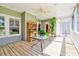 Charming screened porch with a table, plants, and comfortable seating, ideal for entertaining at 4846 Causey Pond Rd, Awendaw, SC 29429