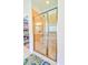 Shower features tan tile, glass door, and bench in primary bathroom at 4846 Causey Pond Rd, Awendaw, SC 29429