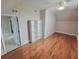 Spacious bedroom featuring hardwood floors, a white bookcase, and a ceiling fan with lights at 609 Sienna Way, Summerville, SC 29486
