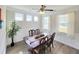 Light and airy dining room featuring three windows, classic furniture and modern ceiling fan at 609 Sienna Way, Summerville, SC 29486