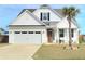 Beautiful exterior showcasing a well-manicured lawn, two car garage and charming architectural details at 609 Sienna Way, Summerville, SC 29486