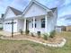Inviting front porch with white columns and decorative landscaping adding charm to this lovely home at 609 Sienna Way, Summerville, SC 29486