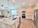Open concept kitchen features a large island, stainless steel appliances, and modern fixtures at 609 Sienna Way, Summerville, SC 29486