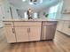 Kitchen island with a stainless steel dishwasher and white cabinets at 609 Sienna Way, Summerville, SC 29486