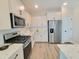Bright kitchen features stainless steel appliances, white cabinetry, and granite countertops at 609 Sienna Way, Summerville, SC 29486