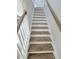 Clean staircase with white risers and wooden treads and handrail at 609 Sienna Way, Summerville, SC 29486