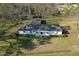 Aerial view of a home showing its layout, roof, and surrounding lawn with mature trees at 6156 Badham Dr, Reevesville, SC 29471